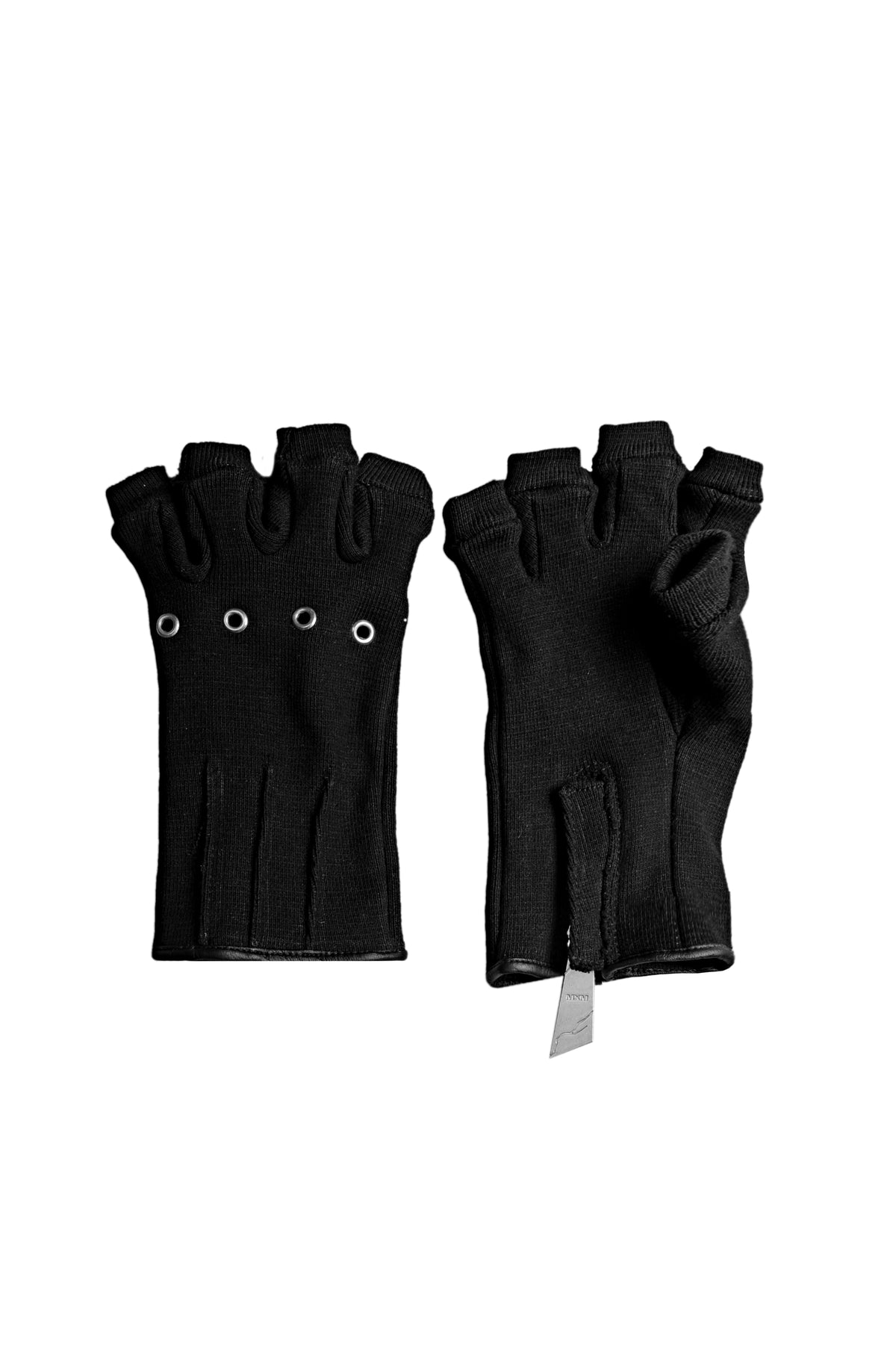 Ākhira Rib Gloves in black cotton rib, fingerless, with metal knuckle eyelets, shown as a pair on white